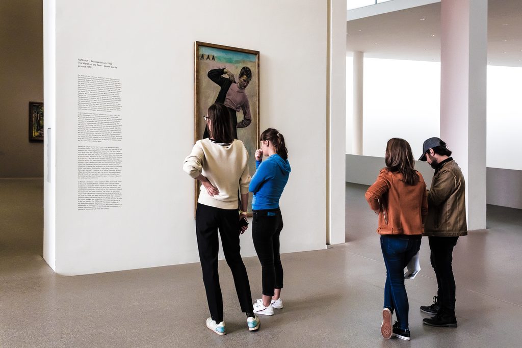 Besucher betrachten Kunstwerke in einer modernen Museumsausstellung